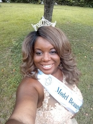 Model Beauty USA queen wearing crown and sash